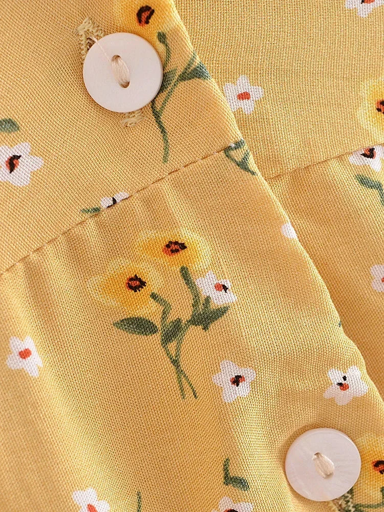 Nyla Flutter Mini Dress from Shop the Kei - close up of white button closure, yellow and white floral pattern textile, and texture 