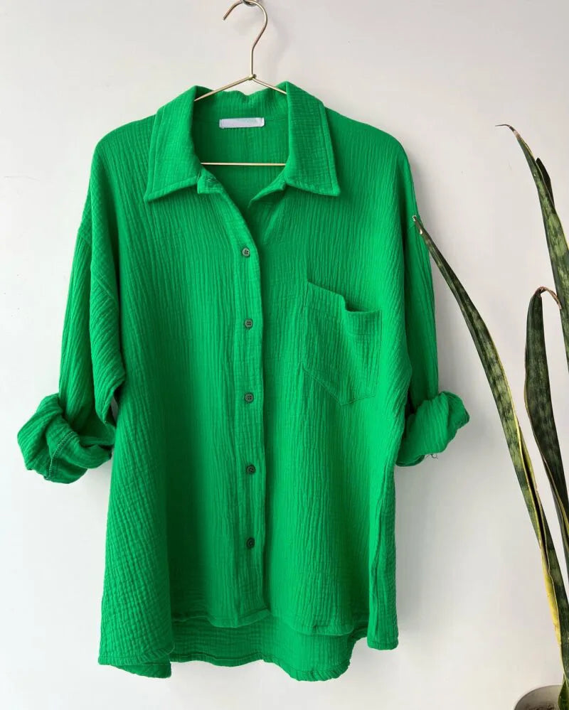 Colada Shorts Set from Shop the Kei - a vibrant green matching shorts set featuring a textured fabric with subtle vertical ribbing. The image displays a buttoned collared shirt with breast pocket and rolled up sleeves. Photographed against a plain white background