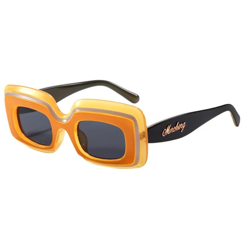 Citrine Retro Shades sunglasses, a yellow-orange frame with black temple arms and dark gradient lenses, shown at a three-quarter angle on a white background.