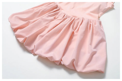 Close up of the Rinay Sport Dress. Image shows the blouson skirt puffed hemline