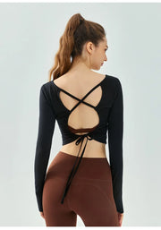 Eden Seamless Cross Back Top from Shop the Kei - back view of soft and breathable dancer inspired long sleeve top with adjustable back straps that tie at the hem. Pairs well with yoga pants.