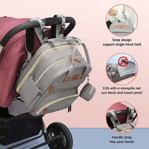 Gray Lotus 3-in-1 Bassinet Diaper Bag backpack shows different ways to carry the bag - over stroller handle, hand held, or on the ground for naps and changing