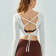 Eden Seamless Cross Back Top from Shop the Kei - cloud white color option back view of soft and breathable dancer inspired long sleeve top with adjustable back straps that tie at the hem.