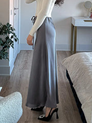 Bela Satin Maxi Skirt from Shop the Kei - side view - gray bias fitting skirt looks more formal with sparkly heels.