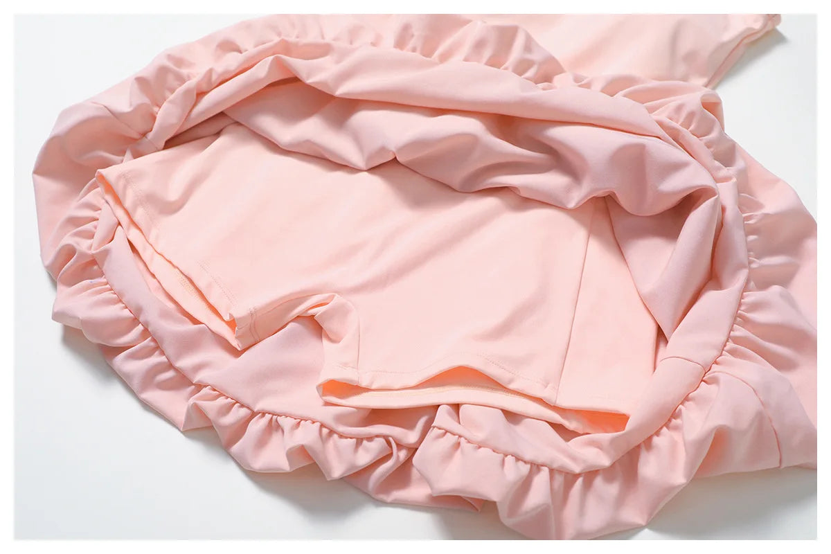 Close up of the Rinay Sport Dress. Image shows the blouson skirt puffed hemline , lining, and attached shorts inside