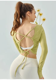 Eden Seamless Cross Back Top from Shop the Kei - back view of soft and breathable dancer inspired long sleeve top with adjustable back straps that tie at the hem. Pairs well with yoga pants.