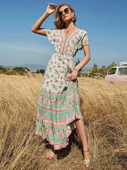 Birdie Summer Midi Dress from Shop the Kei - featuring a bohemian styled dress with flower print, v neck button closure, adjustable waist tie, soft natural textile and texture, and flounce hem. Pairs well with tan sandals and gold jewelry