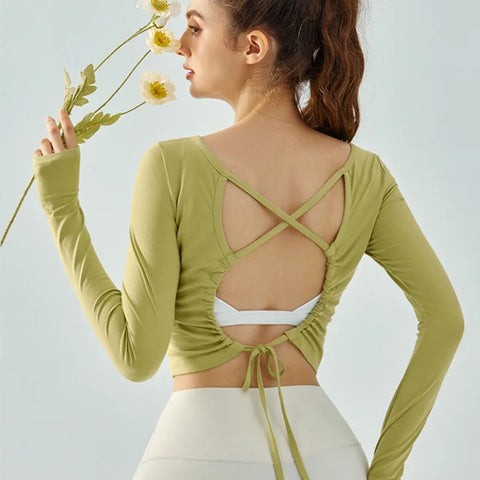 Eden Seamless Cross Back Top from Shop the Kei - light green color option back view of soft and breathable dancer inspired long sleeve top with adjustable back straps that tie at the hem.