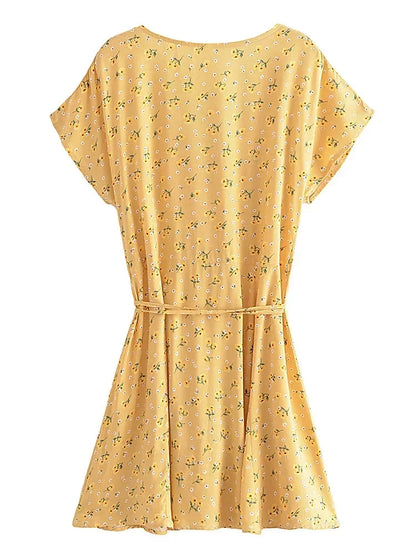 Nyla Flutter Mini Dress from Shop the Kei - back view of flowing yellow and white floral short dress on white background