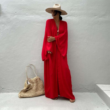 Front view of model wearing the red Sole Kimono from Shop the Kei shown with a white bikini top, gold heels, straw hat and beach tote . A Bohemian-style ankle-length beach cover-up kimono with wide sleeves and matching waist sash, perfect for vacation, poolside, or post-swim lounging.