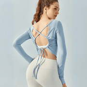 Eden Seamless Cross Back Top from Shop the Kei - back view of soft and breathable dancer inspired long sleeve top with adjustable back straps that tie at the hem. Pairs well with yoga pants.