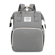 Gray Lotus 3-in-1 Bassinet Diaper Bag with   cream trim zippers, wide backpack straps, and multiple compartments for baby essentials. Partial canopy available