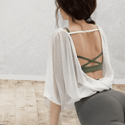 Veda Butterfly Top from Shop the Kei -  featuring a backless design with a twisted hem, fluttery short sleeves, and made of sheer breathable fabric. Pairs great with a sports bra and yoga pants