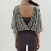 Veda Butterfly Top from Shop the Kei -  back view of the gray color option wrap hemline can also be worn to the front and over a cute sports bra or body suit.