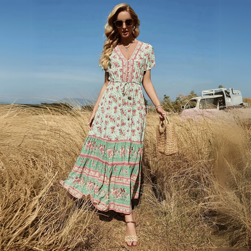 Birdie Summer Midi Dress from Shop the Kei - featuring a bohemian styled dress with flower print, v neck button closure, adjustable waist tie, soft natural textile and texture, and flounce hem. Pairs well with tan sandals and gold jewelry