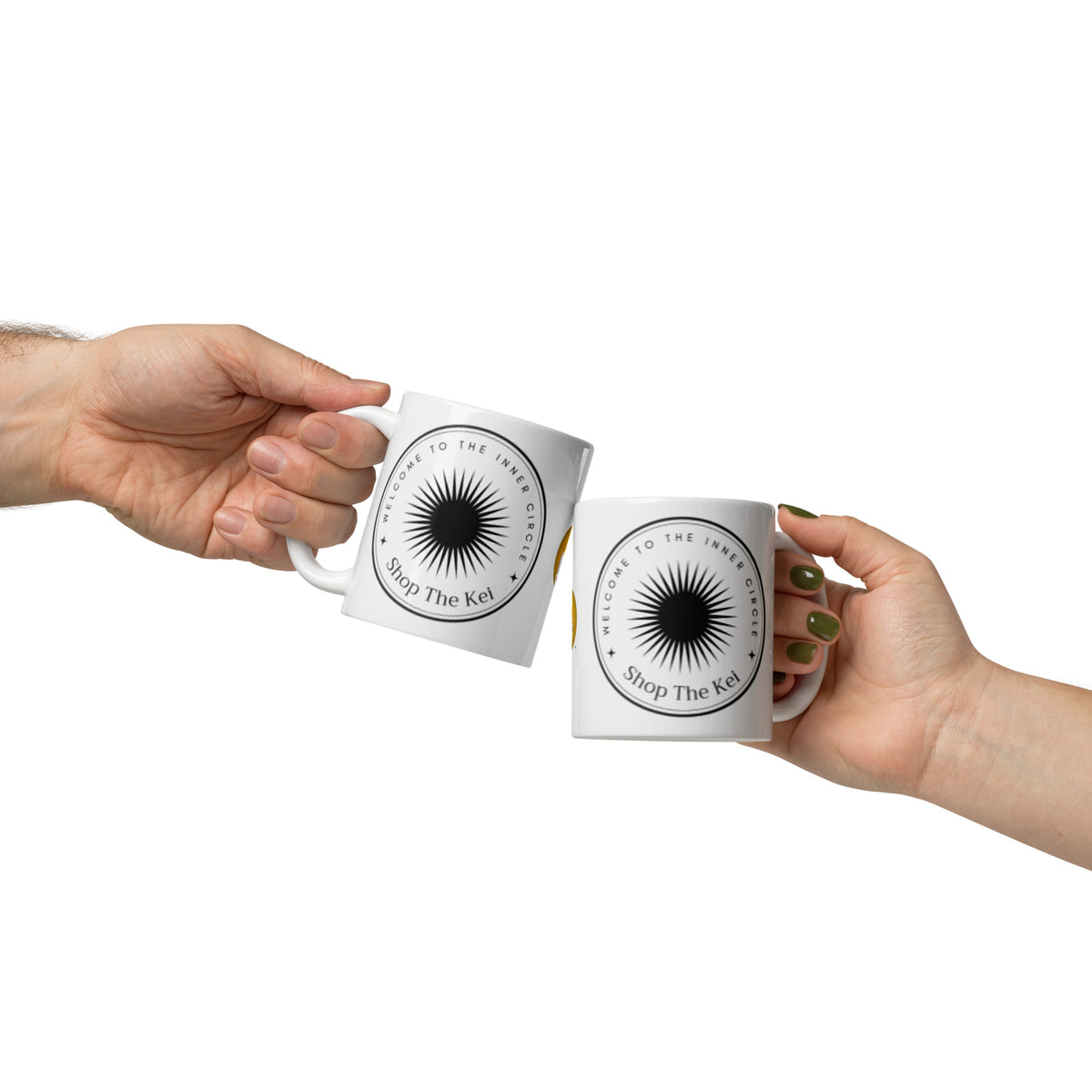 Two hands raising Inner Circle Mugs together in a toast