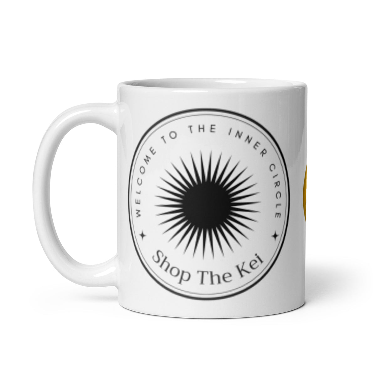 Inner Circle Mug with the handle on the left, showing the sunburst emblem and Shop The Kei wordmark