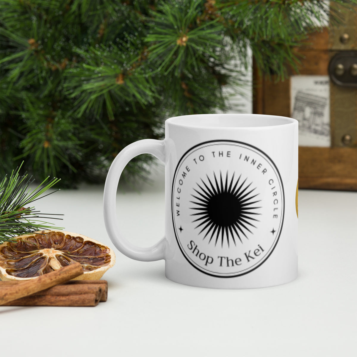Inner Circle Mug beside pine branches, dried orange slices and cinnamon sticks