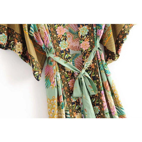 Close up view of Nyma Kimono from Shop The Kei swim collection. Image depicts the intricate print details and natural textile texture of the front and waist details