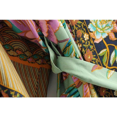 Close up view of Nyma Kimono from Shop The Kei swim collection. Image depicts the intricate print details and natural textile texture of the waist sash and loops