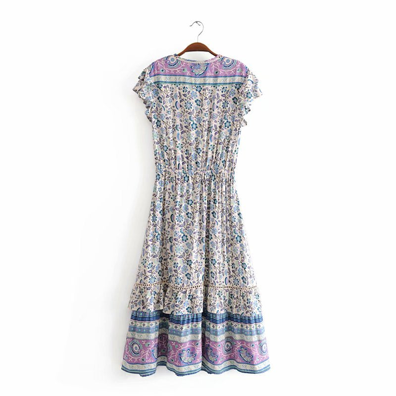 Nala Midi Dress from Shop The Kei - Full length back view of blue and purple floral boho midi dress with yoke, ruffle details, and flounce hem. Dress is shown against a plain white background