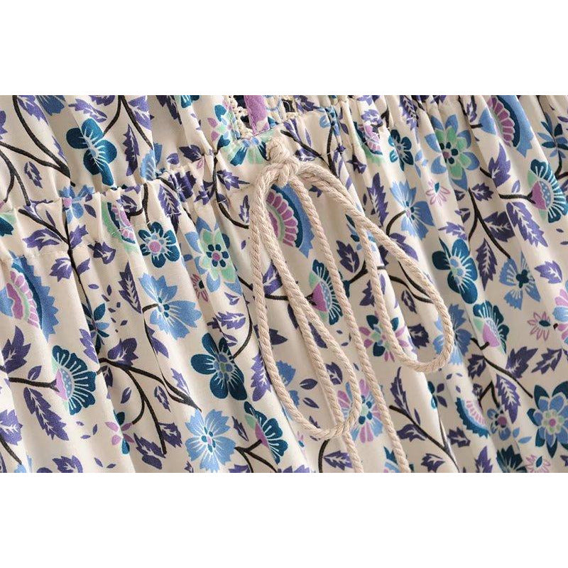 Nala Midi Dress from Shop The Kei - close up detail of white waist tie, blue and purple floral boho print colors and natural textile textures