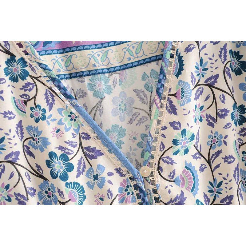 Nala Midi Dress from Shop The Kei - close up detail of v neckline construction, lace details, button closure with white buttons, blue and purple floral boho print colors and natural textile textures