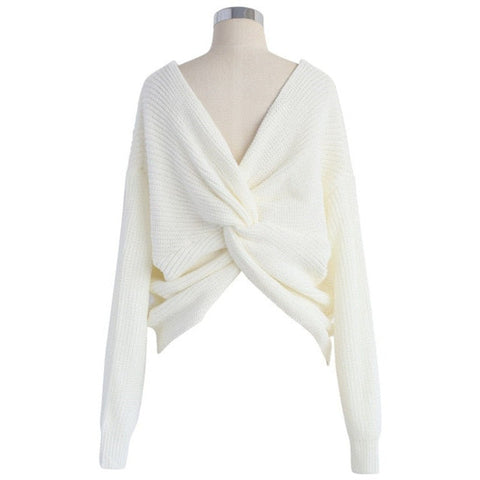 Close-up of the Aries Sweater in milk white featuring a distinctive twisted front knot design. Chunky sweater photographed on a mannequin with a white background